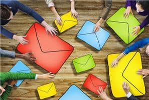 A lot of colorful envelopes in different colors being shuffled around by a group of people